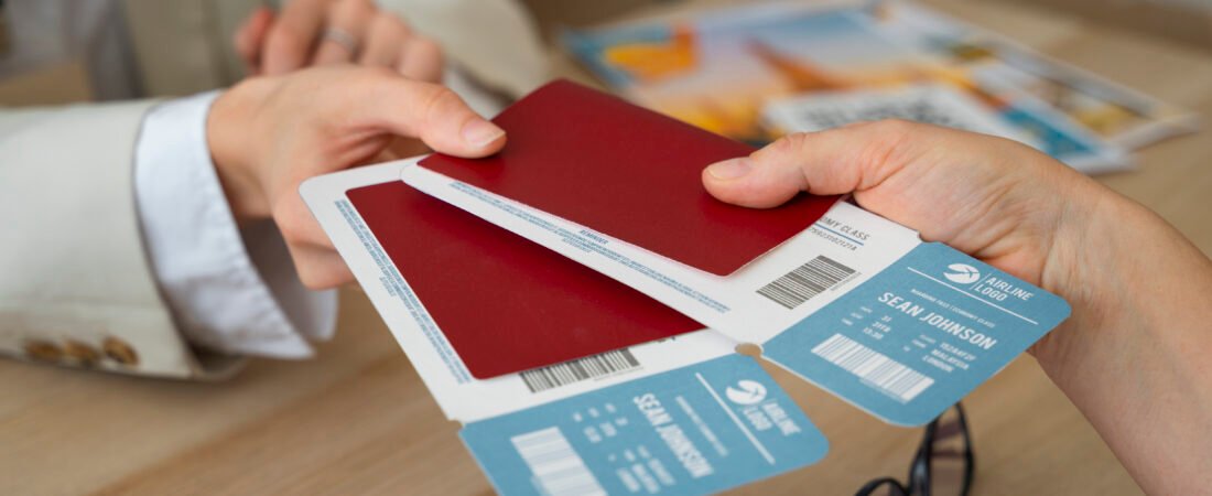 Travel agent handing airline tickets and passports to a traveler