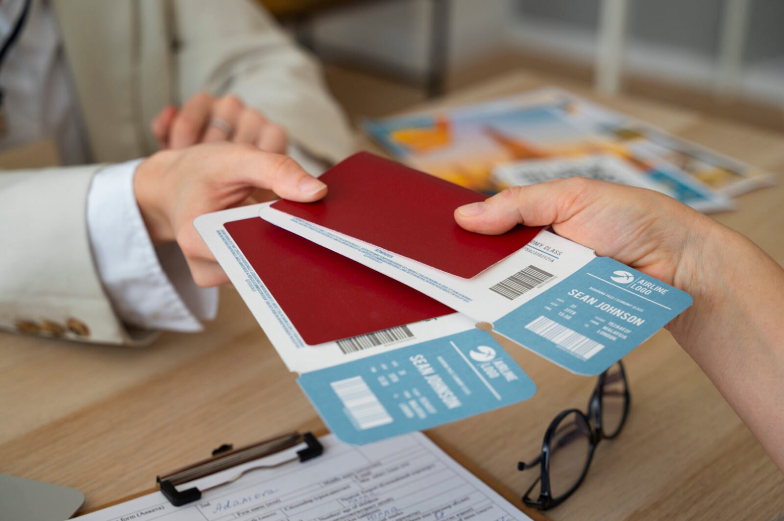 Travel agent handing airline tickets and passports to a traveler