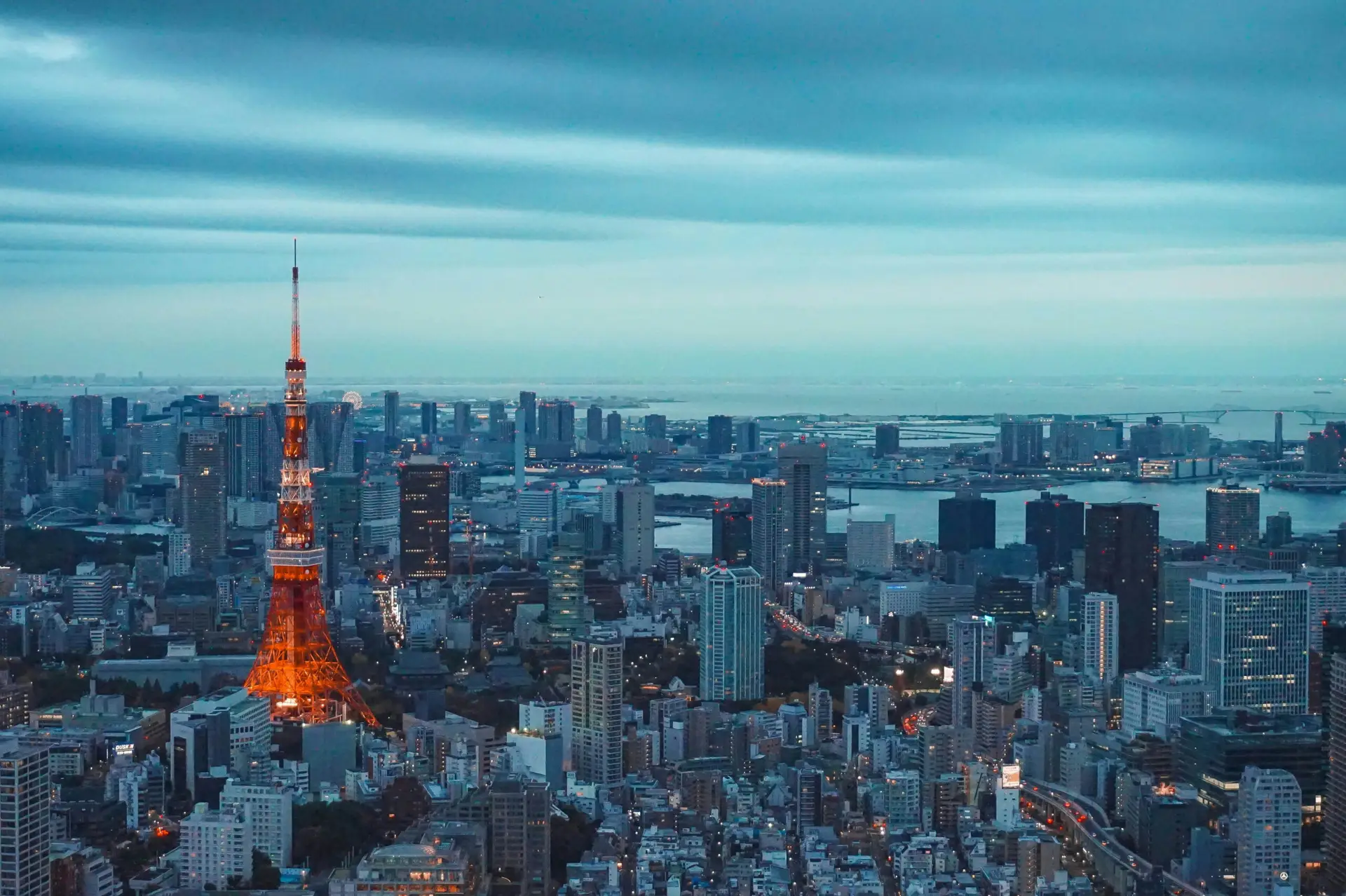 Tokyo Tower illuminated at dusk above the Tokyo city skyline in Japan